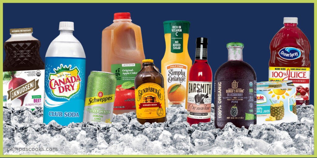 A selection of non-alcoholic mixers settled in ice cubes, like orange juice, a bottle of grenadine, apple cider, can of lemon seltzer and more.